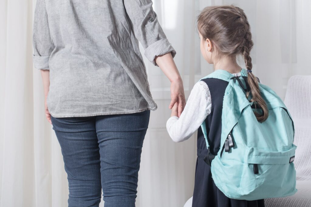 Parent and primary school student go hand in hand